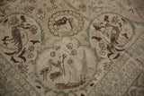 Distressed Persian Tabriz rug detail showing coffee brown birds, palmettes, and faint foundation wear.