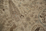 Distressed vintage Tabriz carpet with faded floral motifs and foundation showing through.