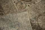 Corner of Vintage Distressed Tabriz carpet showing low pile, faint foundation, and intact selvage.