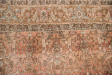 Close-up of the distressed Bijar carpet's hand-knotted pile, with floral and vine motifs.