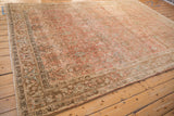 Side view of a vintage distressed Bijar rug highlighting its intricate border and time-softened colors.