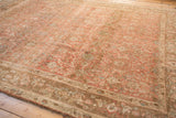 Angled view of the distressed Bijar carpet, showing its short pile and allover floral pattern.