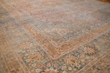 Distressed vintage Meshed carpet corner: faded raspberry, blue palmettes, and brown spandrel.
