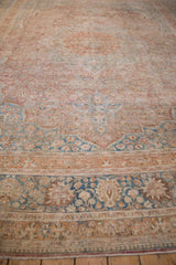 Distressed vintage Persian Meshed carpet border with palmette blossoms, faded raspberry and blue.