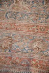 Faded raspberry and sky blue palmette border on a distressed vintage Meshed rug.