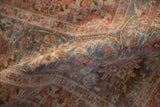 Distressed pile of vintage Meshed carpet with faded raspberry, sky blue, and ivory.