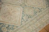 Distressed Hamadan runner pile, showing faded diamond patterns and a minor striped border.