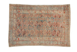 Vintage distressed Mehriban rug with an allover scrolled leaf design in dusty blue, ivory, and red.