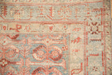 Sharp serrated leaf and palmette border detail on a distressed vintage Persian rug.