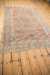 Angled perspective of the vintage distressed Mehriban rug, showing its low-pile texture and allover pattern.