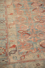 Angled view of the fine, worn pile and serrated leaf and palmette border motifs.