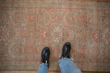 The soft, distressed texture and visible knot heads of a vintage Persian Hamadan runner.