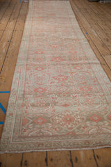Angled view of a vintage Hamadan runner's full length, showing its distressed, allover pattern.