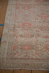 Detail of the worn pile and narrow meandering vine border of the vintage runner.