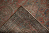 Folded corner of a distressed Hamadan runner showing its hand-knotted back and restored side cord.