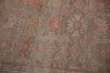 Detailed texture of a distressed Hamadan runner with ruby red and sapphire blue Herati motifs.