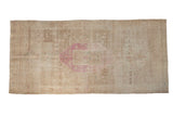 Vintage distressed Bijar rug with a magenta medallion, heavy abrashes, and a sand and pale coffee brown field.