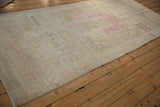 Angled view of a vintage Persian Bijar runner, showing its low, worn pile and textural abrashes.