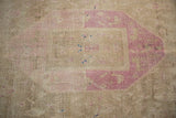 Even wear to knot heads on a distressed Bijar runner in magenta and beige hues.