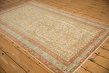 Full angled view of a distressed Mehriban rug showing its triple diamond medallions and floral field.