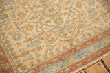 Meandering rust and blue vine border on a vintage Mehriban rug showing its low, knotty pile.
