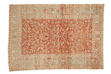 Distressed Heriz carpet: ruby red medallion field, geometric florals, faded blue border. 5'10