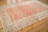 Distressed Heriz rug corner showing geometric floral patterns and Turtle Samovar border elements.