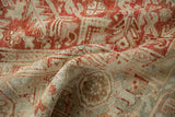 Textured distressed Heriz carpet showing ruby red and beige geometric patterns, with subtle blue.