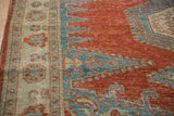 Distressed, low pile corner of a hand-knotted vintage Veece rug in cherry red and sapphire blue.