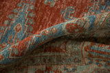 A folded view of the machine-bound edge and worn, hand-knotted pile on a vintage Veece carpet.