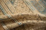 Soft hand-knotted texture of a vintage Oushak rug with pawn motifs in sand and denim blue.