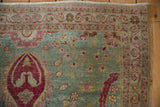 Scrolling arabesque border and palmette with birds in dusty blue and cochineal red.