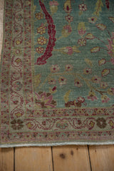 Worn low pile texture on the scrolling arabesque border of a vintage Meshed rug.