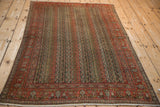 Antique Senneh rug corner: parallel vines, botehs, Herati Mahi motifs, faded brick red border.