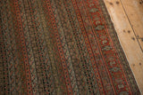 Detailed field of the Senneh rug, showing parallel vines, floral motifs, muted red and ivory.