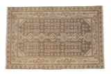 Vintage distressed Hamadan rug with a geometric floral pattern in muted beige, brown, and powder blue shades.