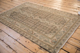 Angled perspective of the vintage Hamadan rug showing its allover geometric pattern and earthy tones.