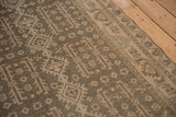 Evenly worn texture of a distressed Hamadan rug with geometric gul motifs in earthy tones.