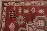Evenly worn pile of a Caucasian rug showing its crab-style and starburst floral motifs.
