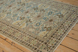 Distressed Tabriz rug corner: antique ivory field, sapphire blue and saffron guls, pawn border.