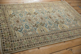 Distressed Tabriz rug corner, pawn motif border, ivory, sapphire blue geometric patterns.