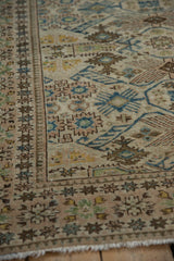 Distressed vintage Tabriz rug with pawn border motif, geometric guls, ivory, blue, gold.