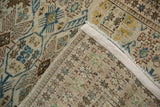 Distressed vintage Tabriz rug showing hand-knotted reverse and finned geometric guls.