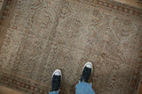 A view from above showing the distressed texture and trellis pattern of a vintage Mahal rug.