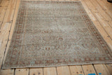 Angled view of the distressed vintage Mahal rug's allover trellis design.
