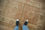 Low-pile texture and even wear of a vintage distressed Afshar rug in muted earth tones.