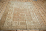 Full angled view of a vintage distressed Afshar rug with a muted, sandy color palette.