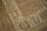 Stylized motifs in the sand and seafoam green geometric border of a vintage Afshar rug.