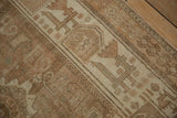 Close view of the distressed Afshar rug's even wear, geometric border, and secured side cord.