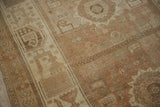 Even wear across the knot heads shows the low pile texture of this distressed Persian rug.